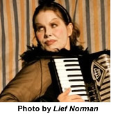 Headshot of Debbie Patterson playing an accordion